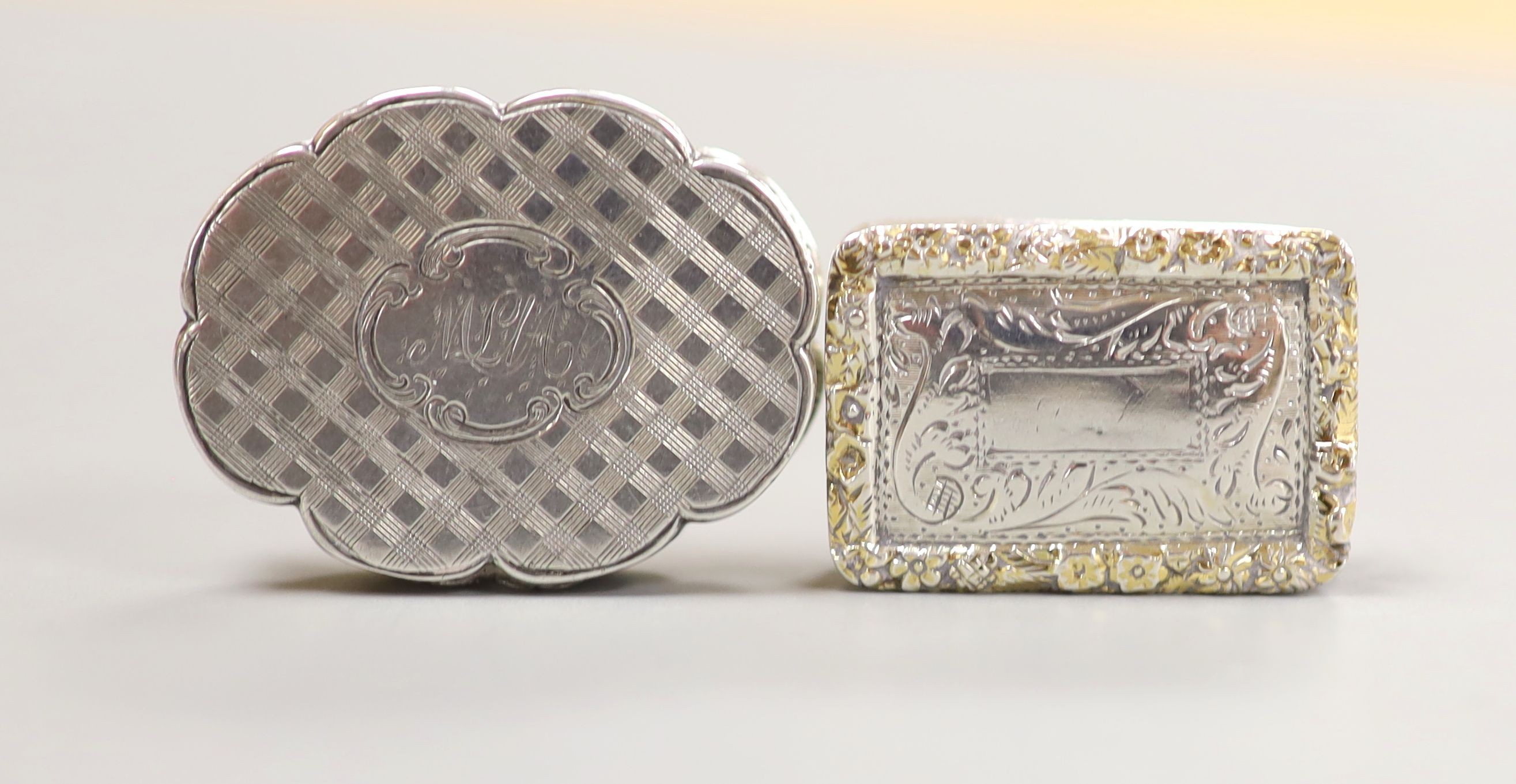 Two Nathaniel Mills silver vinaigrettes, cusped oval shape, 34mm Birmingham, 1849 and gilt border, Birmingham, 1834.